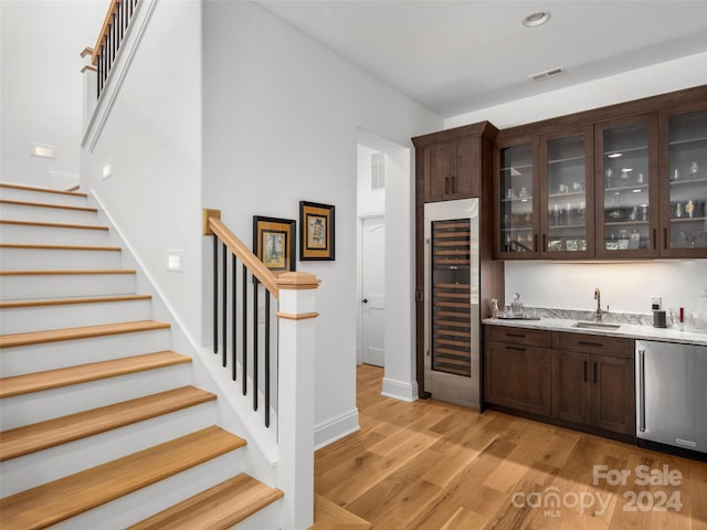 4 Windelsham Way, Arden, NC 28704 - bar with light hardwood / wood-style floors, beverage cooler, dishwasher, sink, and dark brown cabinets