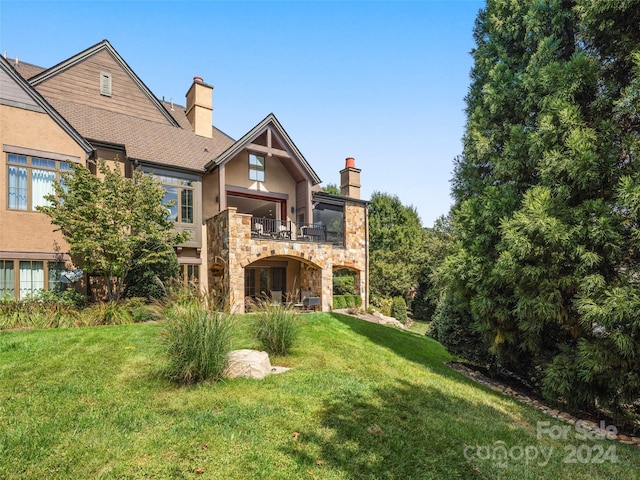 4 Windelsham Way, Arden, NC 28704 - back of property featuring a balcony, a chimney, stone siding, and a yard