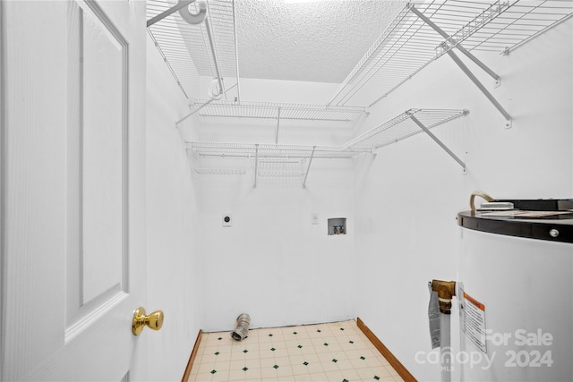 clothes washing area featuring water heater, electric dryer hookup, and hookup for a washing machine