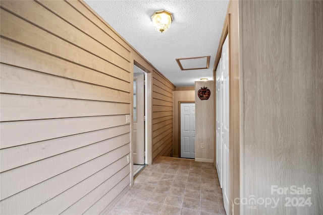 hall featuring wooden walls