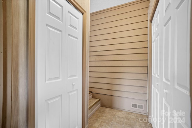 bathroom featuring wood walls