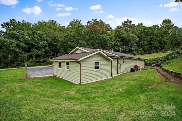 view of property exterior with a yard