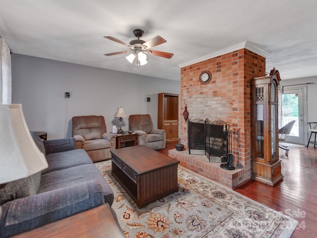 living room featuring a textured ceiling, a fireplace, hardwood / wood-style floors, and ceiling fan