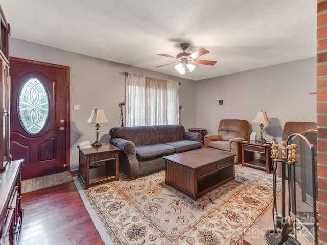 living room featuring ceiling fan, a textured ceiling, plenty of natural light, and light hardwood / wood-style floors