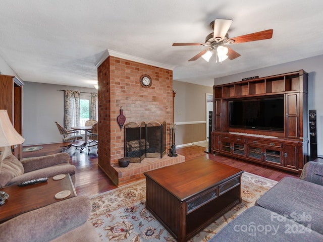 living room with wood-type flooring, a brick fireplace, and ceiling fan