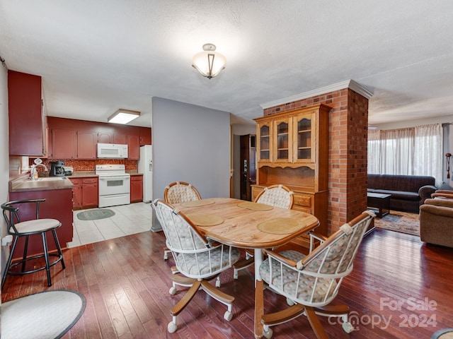 dining area featuring a textured ceiling, sink, and light hardwood / wood-style flooring