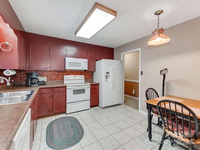 kitchen with backsplash, white appliances, light tile patterned floors, decorative light fixtures, and sink