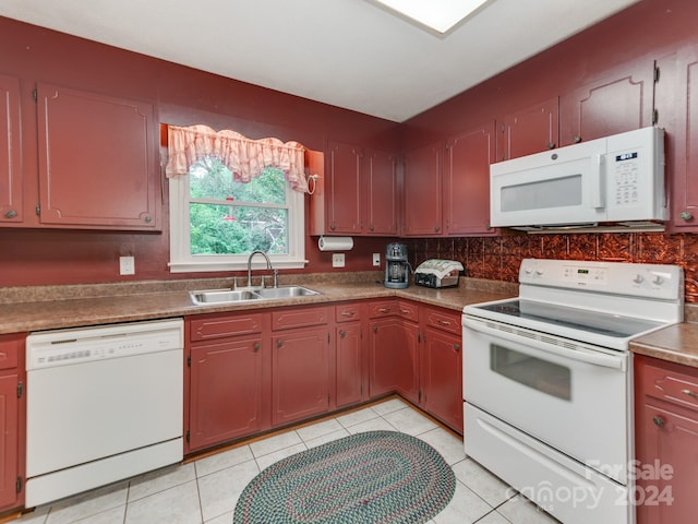 kitchen featuring light tile patterned flooring, sink, and white appliances