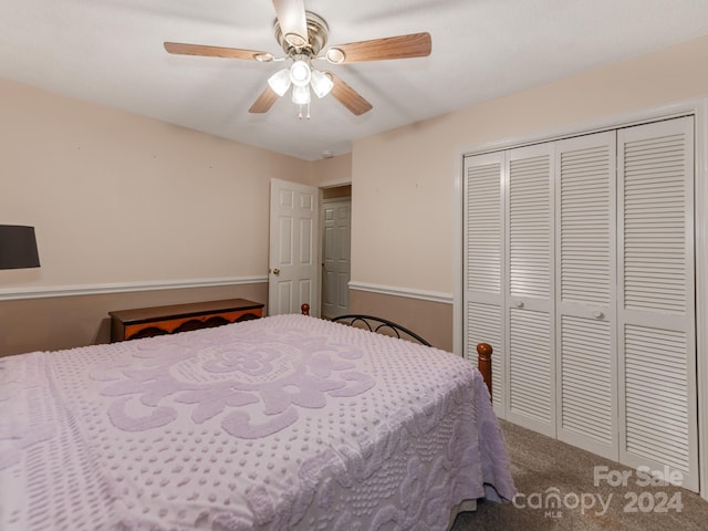 carpeted bedroom with ceiling fan and a closet