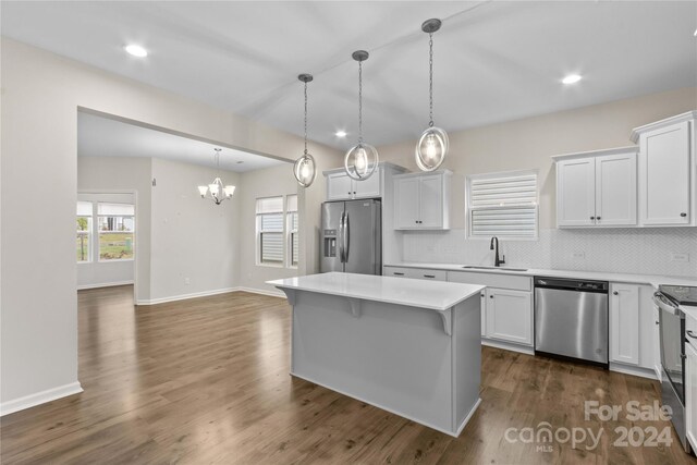 kitchen featuring appliances with stainless steel finishes, a center island, and white cabinets