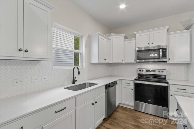 kitchen with stainless steel appliances, dark wood-type flooring, sink, and white cabinetry