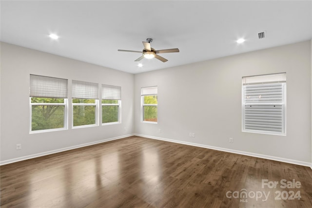 empty room with dark hardwood / wood-style floors and ceiling fan