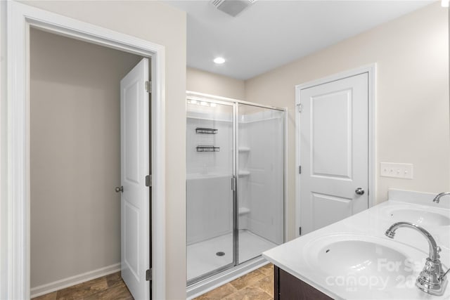 bathroom featuring walk in shower and vanity