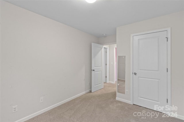 unfurnished bedroom with light carpet