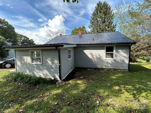 view of side of property with a yard