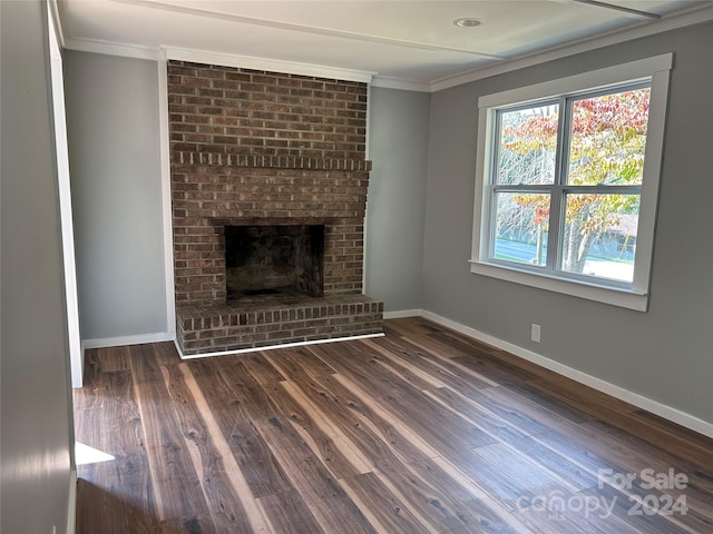 unfurnished living room featuring crown molding, a fireplace, and dark hardwood / wood-style flooring