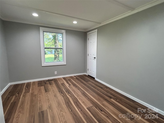 unfurnished room with dark hardwood / wood-style floors and crown molding