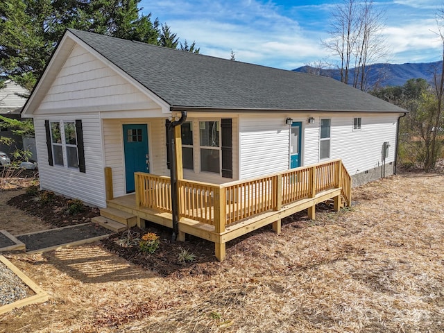 rear view of property with a deck with mountain view