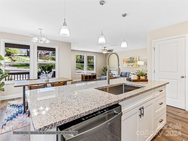 kitchen with dishwasher, white cabinets, ceiling fan with notable chandelier, and hardwood / wood-style flooring