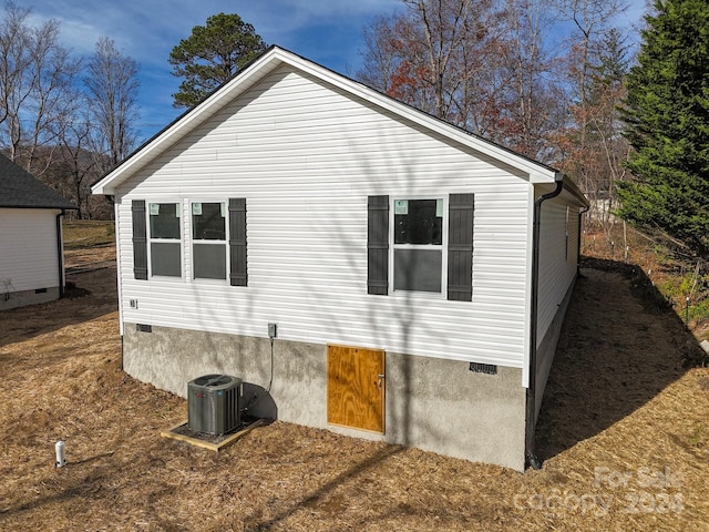 view of side of property featuring central AC