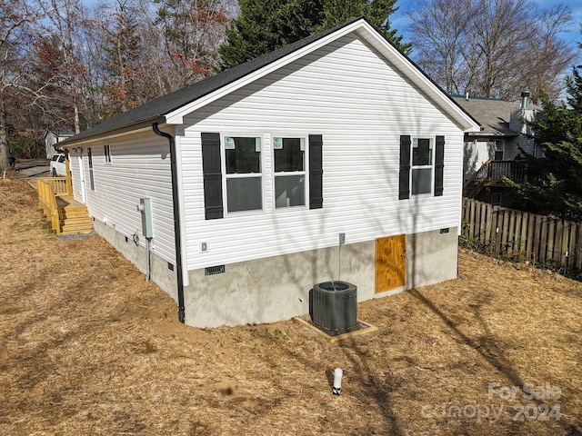 view of side of property with central AC