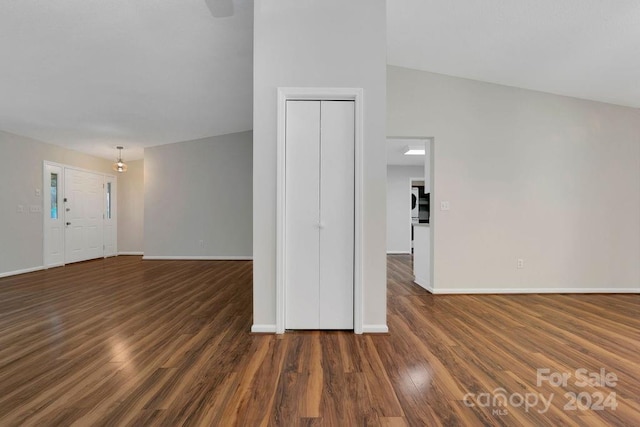 unfurnished room featuring vaulted ceiling and dark hardwood / wood-style flooring