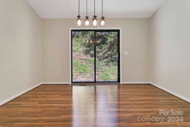 spare room with wood-type flooring