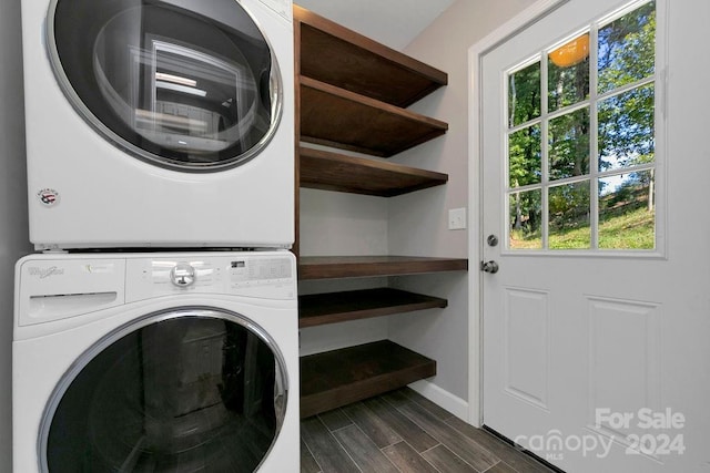 laundry area with stacked washer and dryer and dark hardwood / wood-style flooring