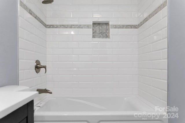 bathroom with vanity and tiled shower / bath combo