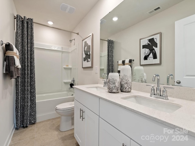 full bathroom with vanity, toilet, shower / bath combo with shower curtain, and tile patterned floors