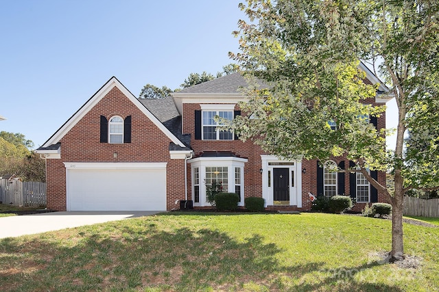 view of front facade with a front yard and a garage