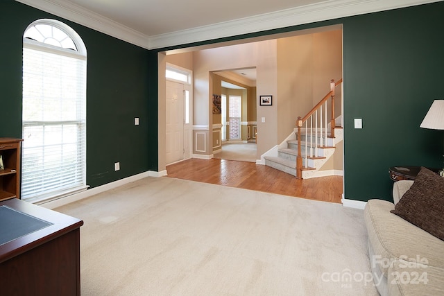 entryway featuring ornamental molding and light hardwood / wood-style floors