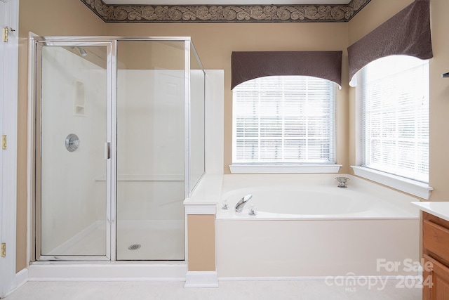 bathroom with vanity, a healthy amount of sunlight, and shower with separate bathtub