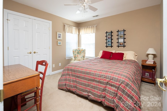 carpeted bedroom with a closet and ceiling fan