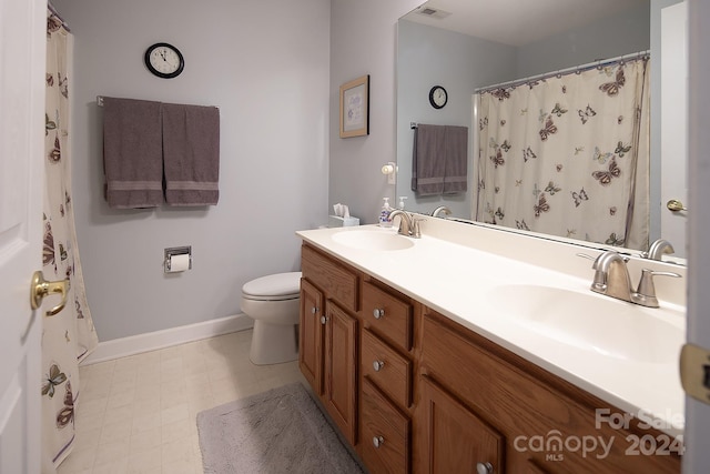 bathroom featuring vanity, toilet, and a shower with shower curtain