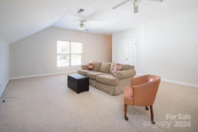 living room featuring ceiling fan, carpet, and lofted ceiling