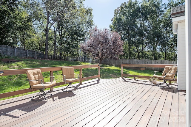 wooden terrace with a yard