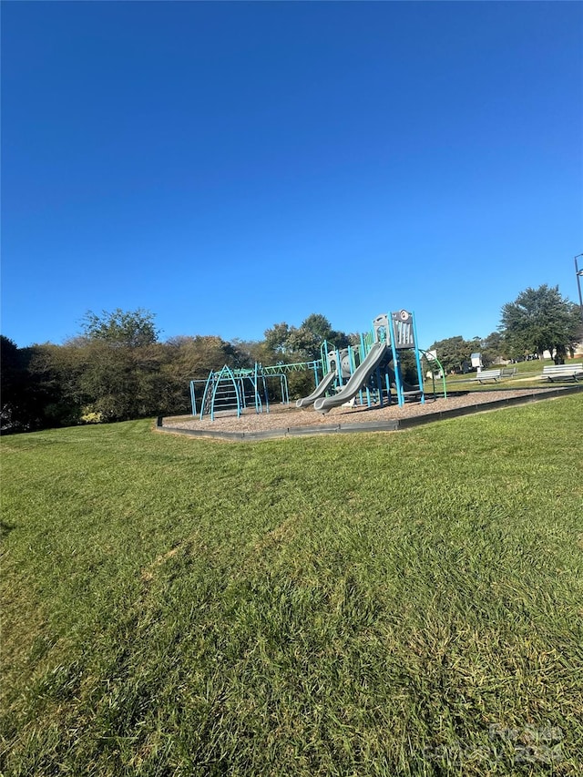 view of playground with a lawn