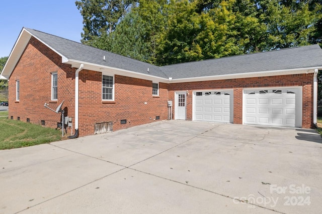 view of side of home featuring a garage