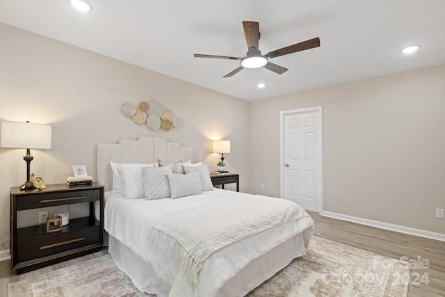 bedroom with light hardwood / wood-style floors and ceiling fan