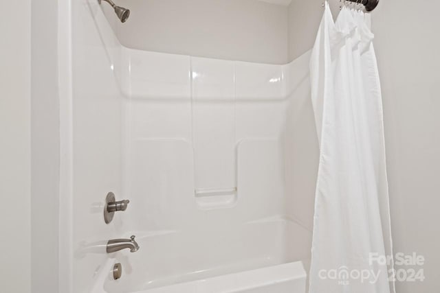 bathroom with shower / bath combination with curtain