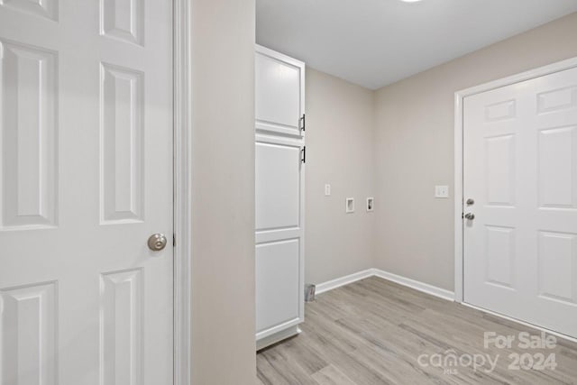 laundry room with light wood-type flooring and hookup for a washing machine