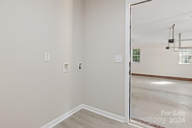 laundry area featuring washer hookup and hardwood / wood-style flooring