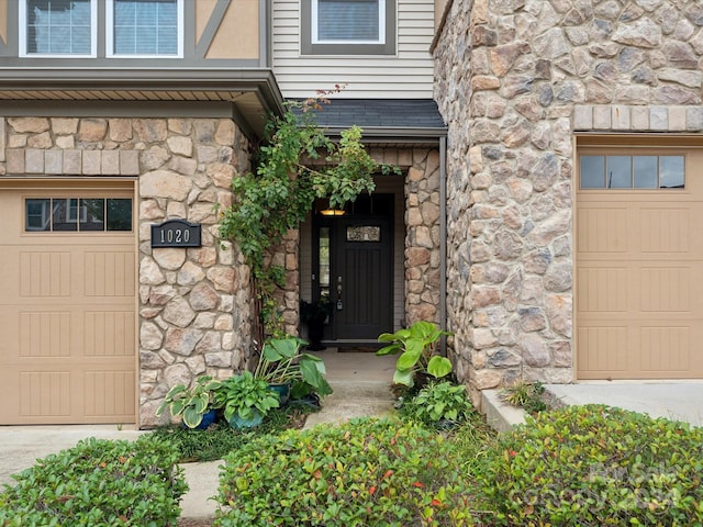 view of exterior entry with a garage