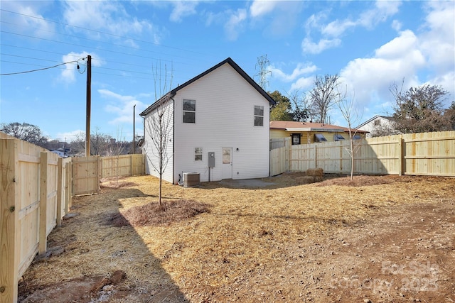 back of house with central AC