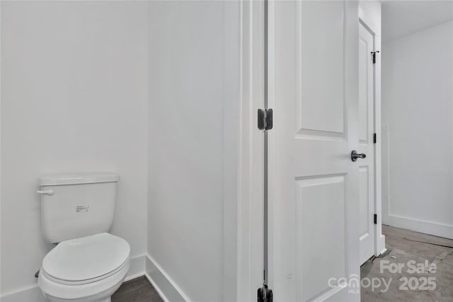 bathroom featuring wood-type flooring and toilet