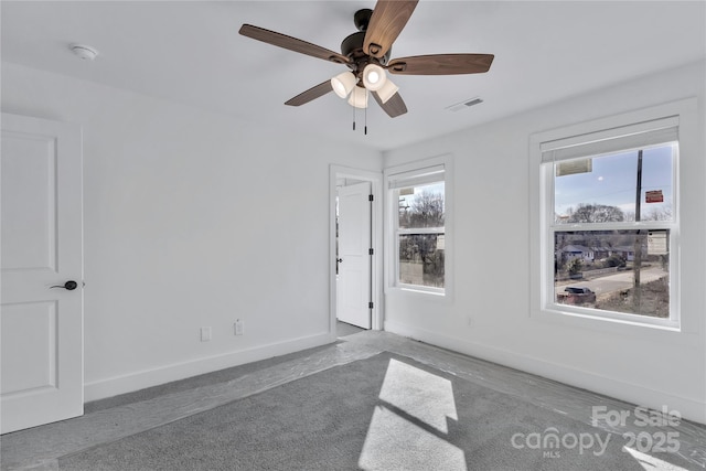 carpeted empty room featuring ceiling fan