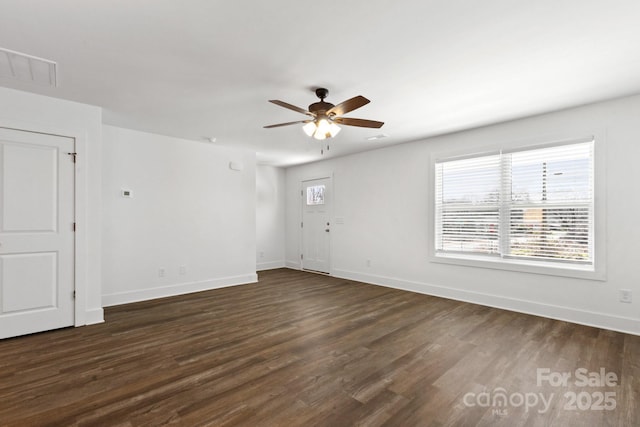 spare room featuring dark hardwood / wood-style floors and ceiling fan