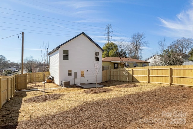 rear view of house with a patio area and central air condition unit