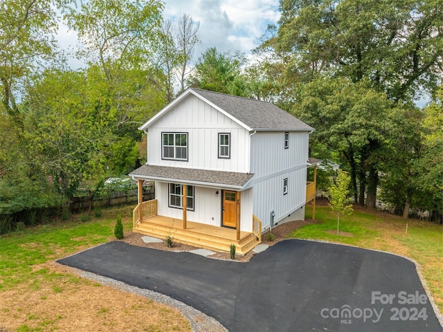 view of front of home featuring covered porch and a front yard